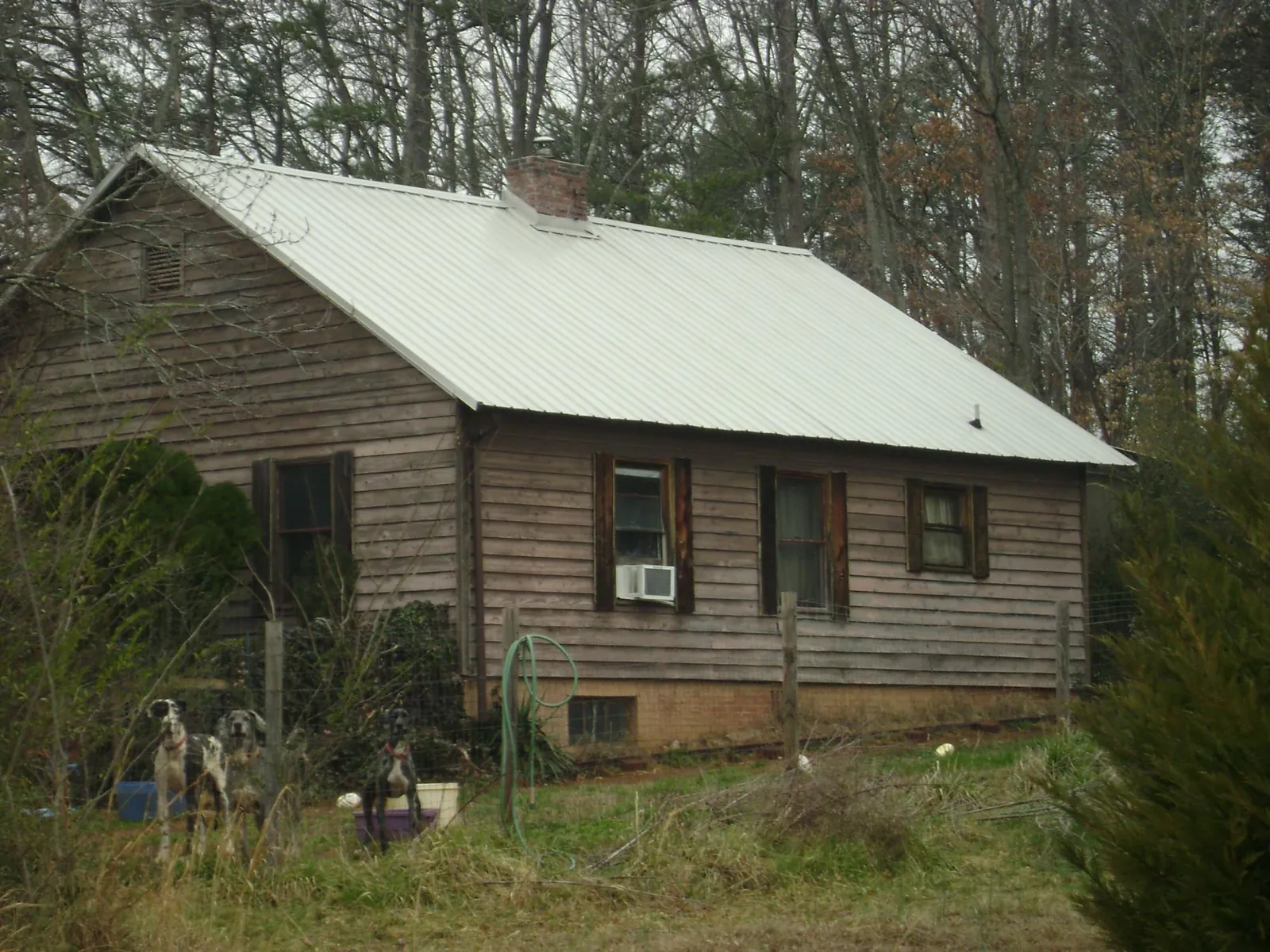 White metal roof on an old wood sided farmhouse, from a Metal Roof Installation job in Weyauwega